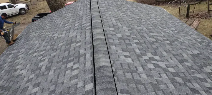 Finished asphalt shingle ridge on a new roof