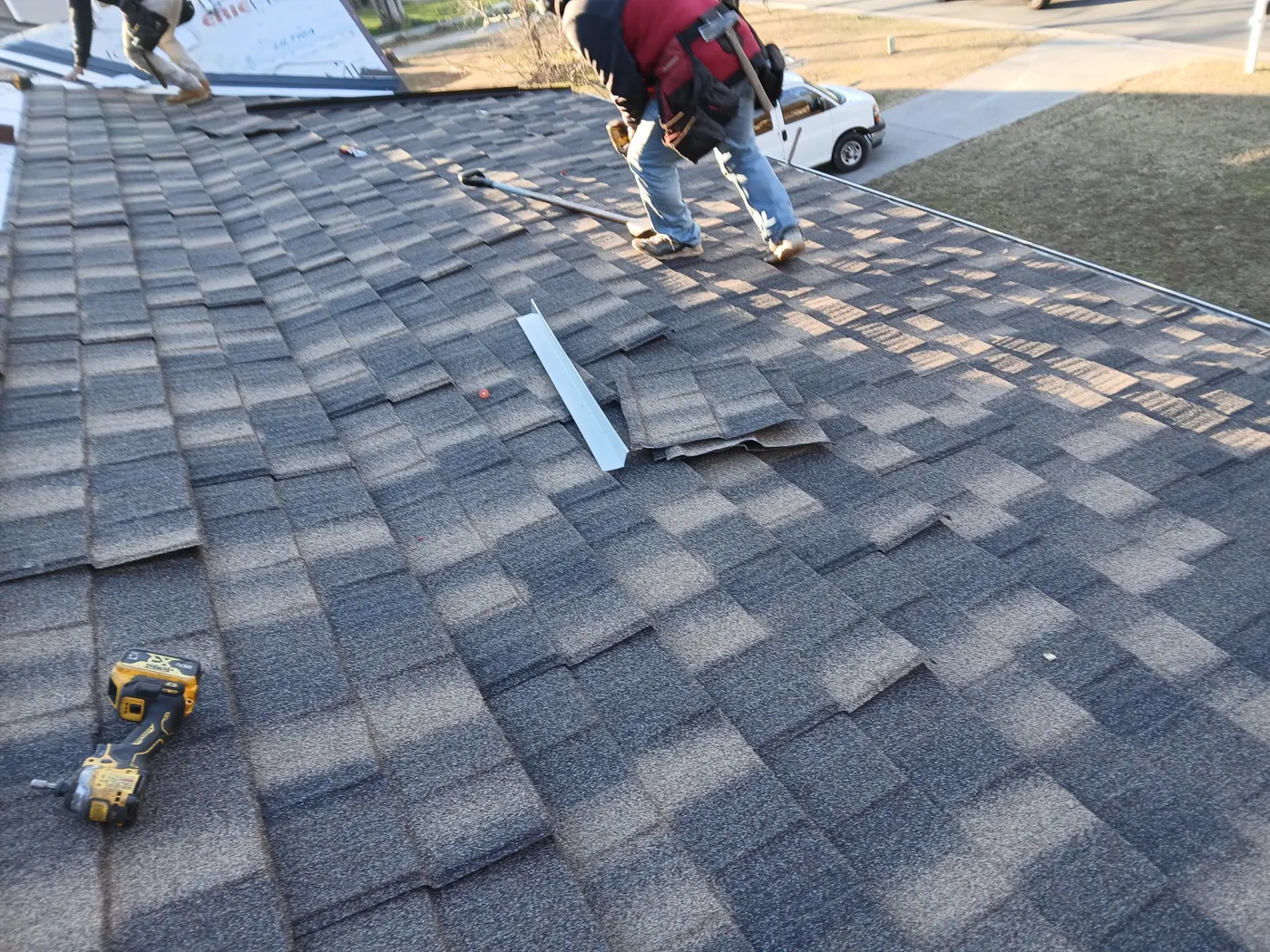 Lifetime Construction Builders crew installing new shingles