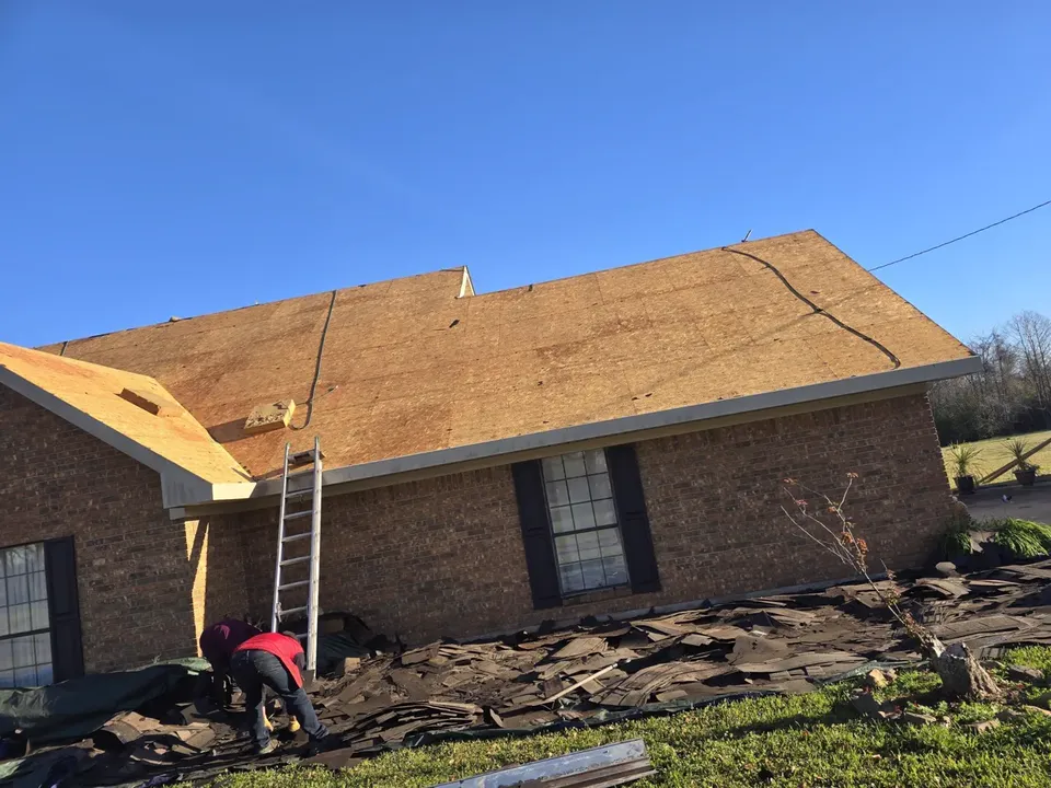 Old roof torn off down to the decking on a brick house